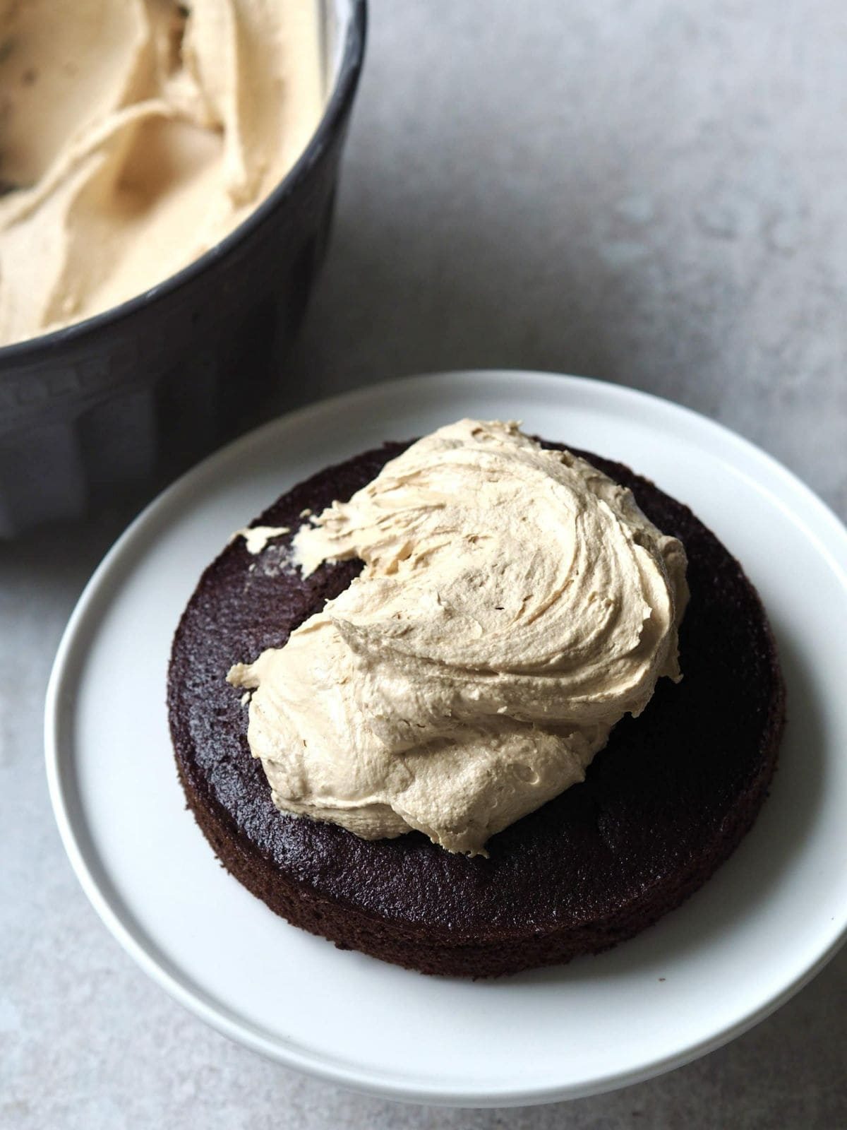 adding biscoff buttercream to the chocolate cake.