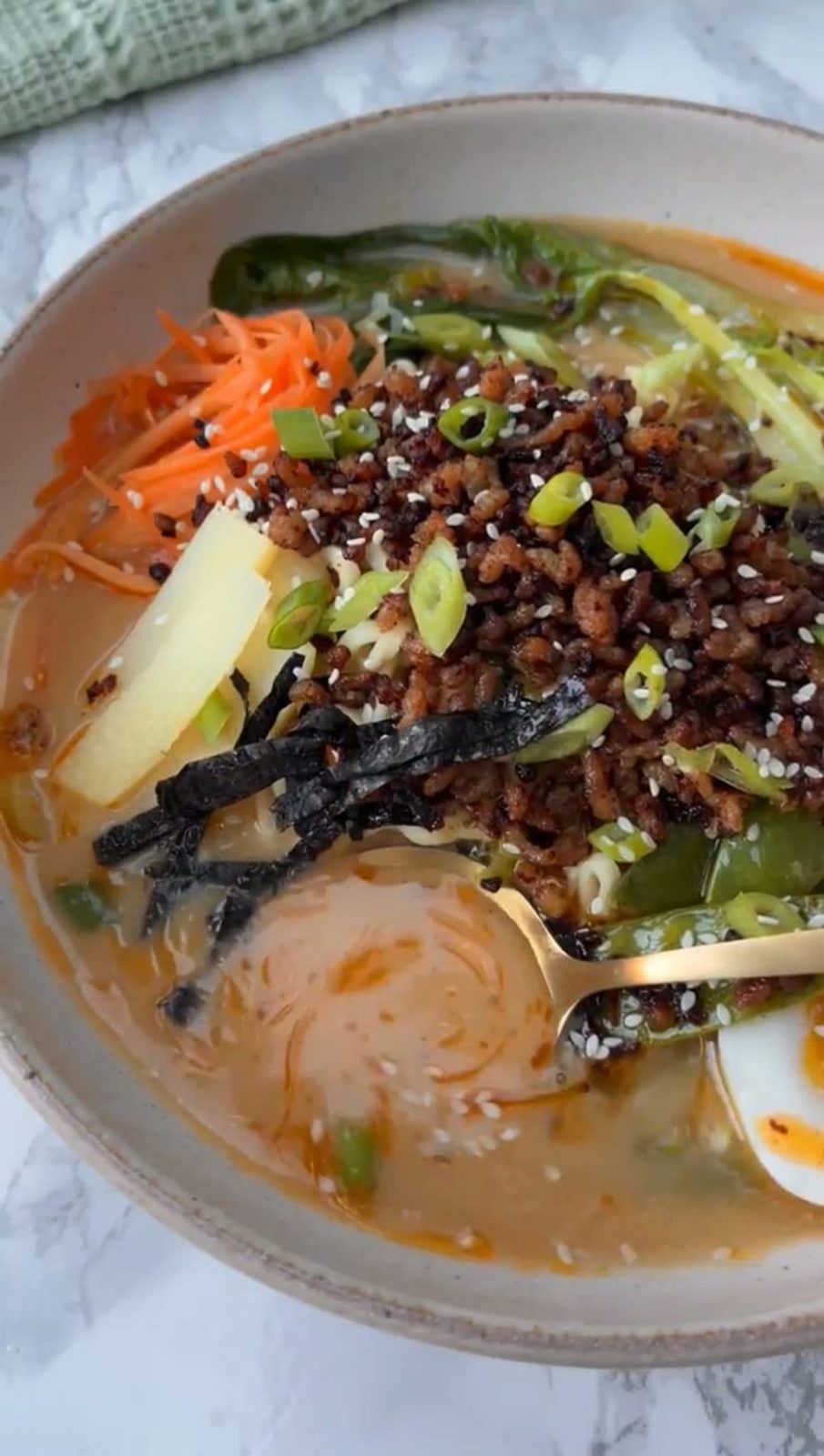 A spoon in the broth of the easy pork ramen
