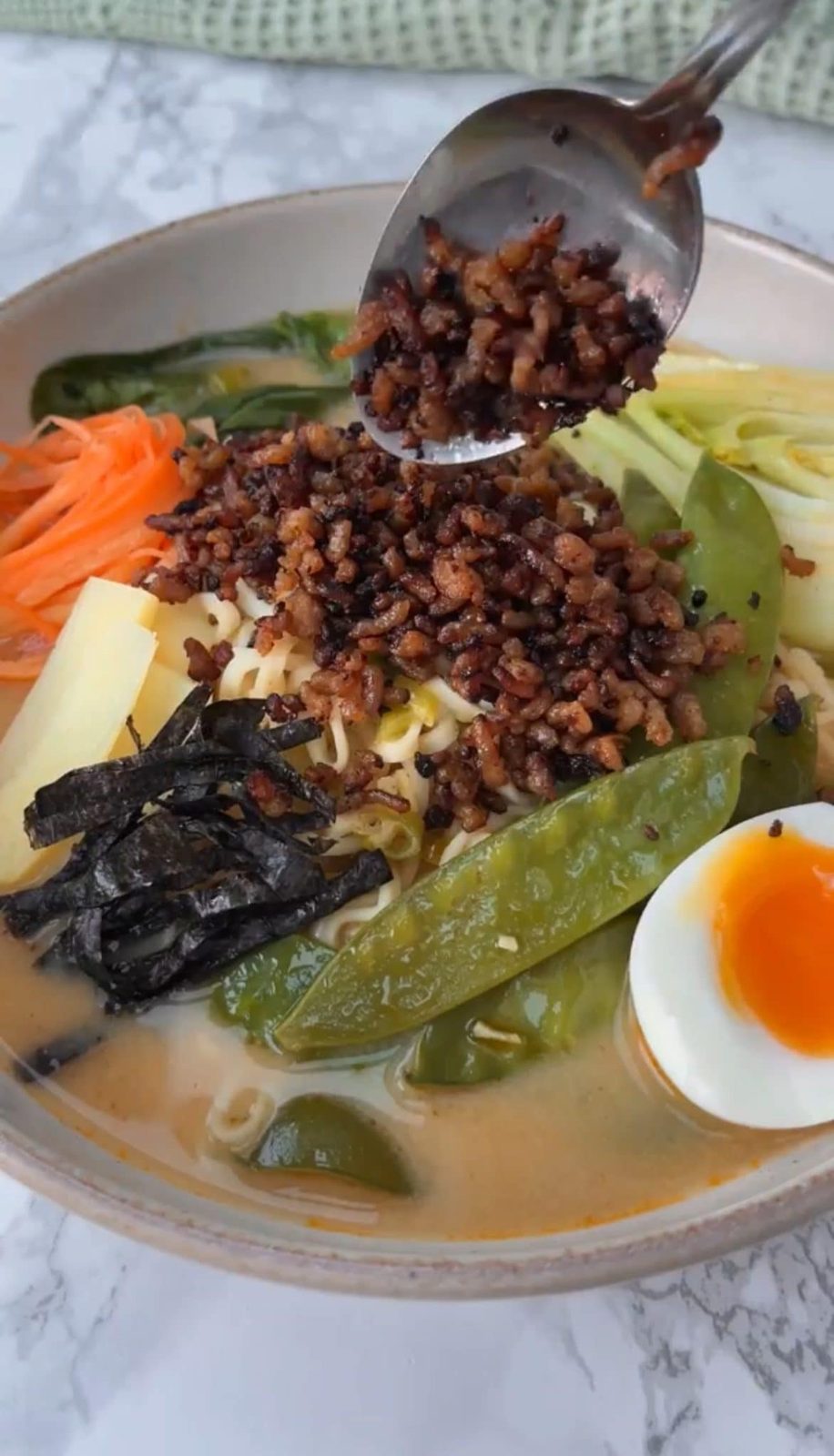 Adding crispy pork to the easy pork ramen