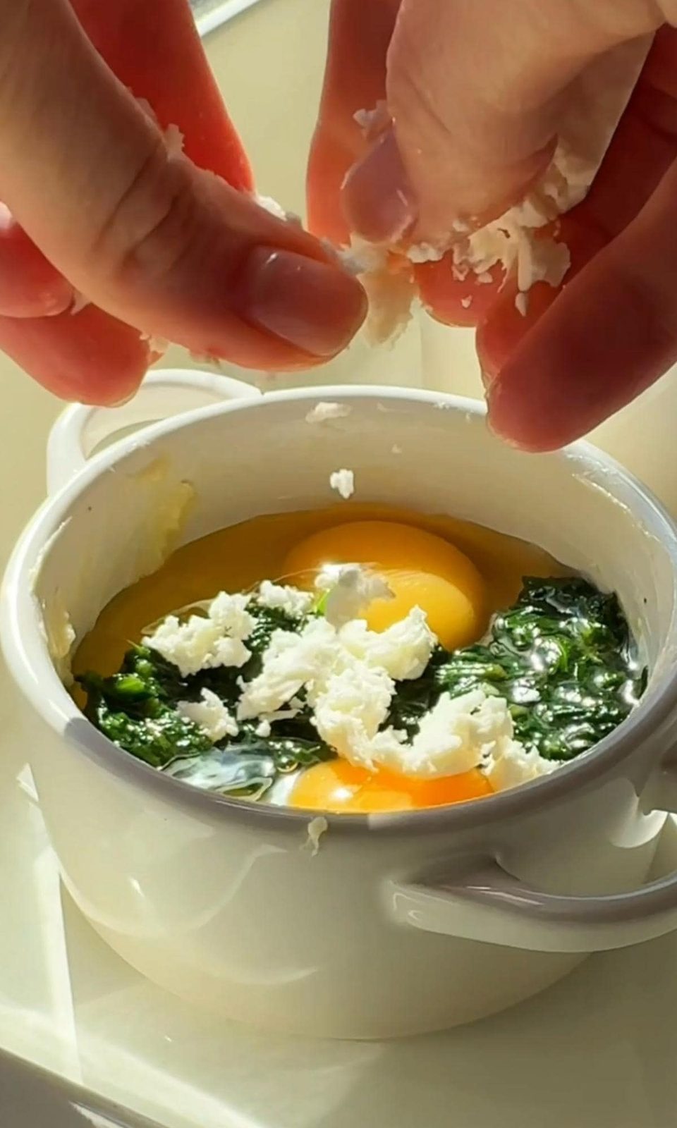 adding feta to eggs.