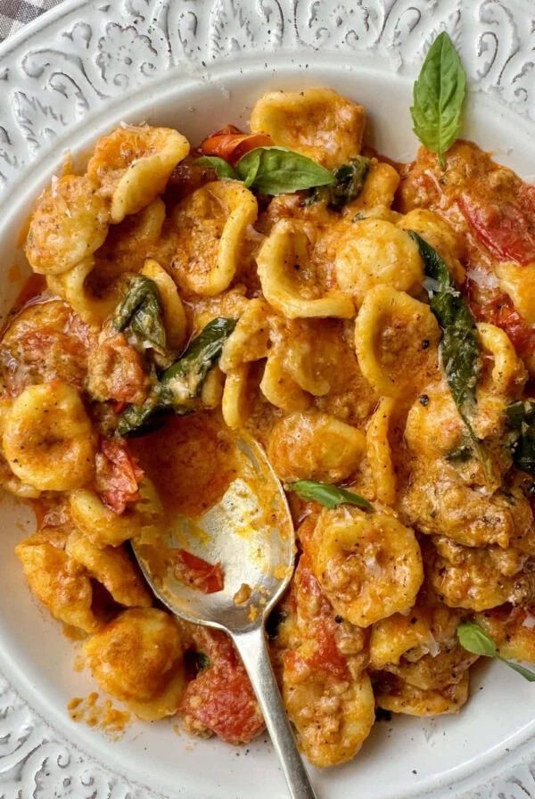 pasta con nduja in a white bowl.