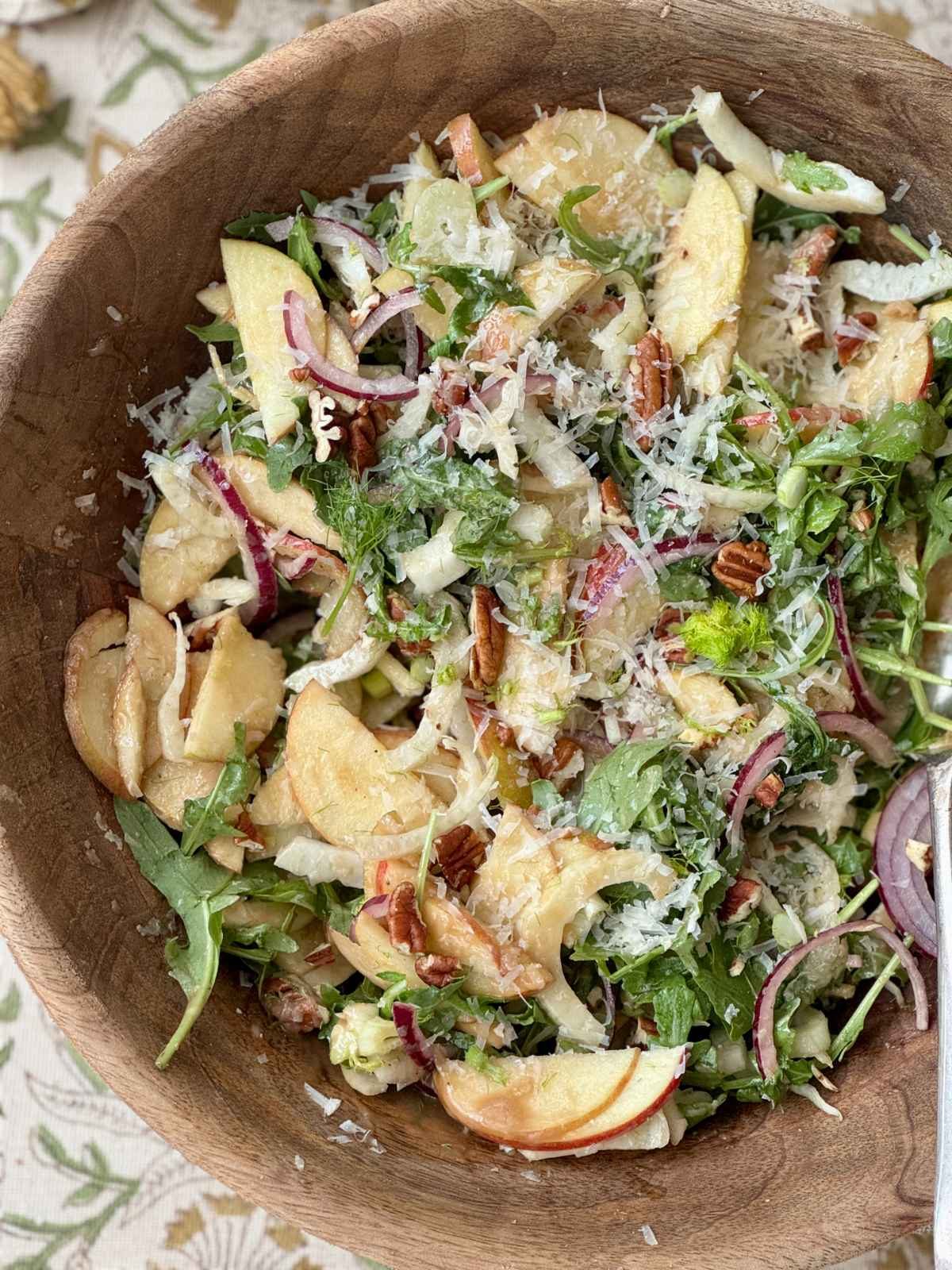fennel apple salad in a wooden bowl.