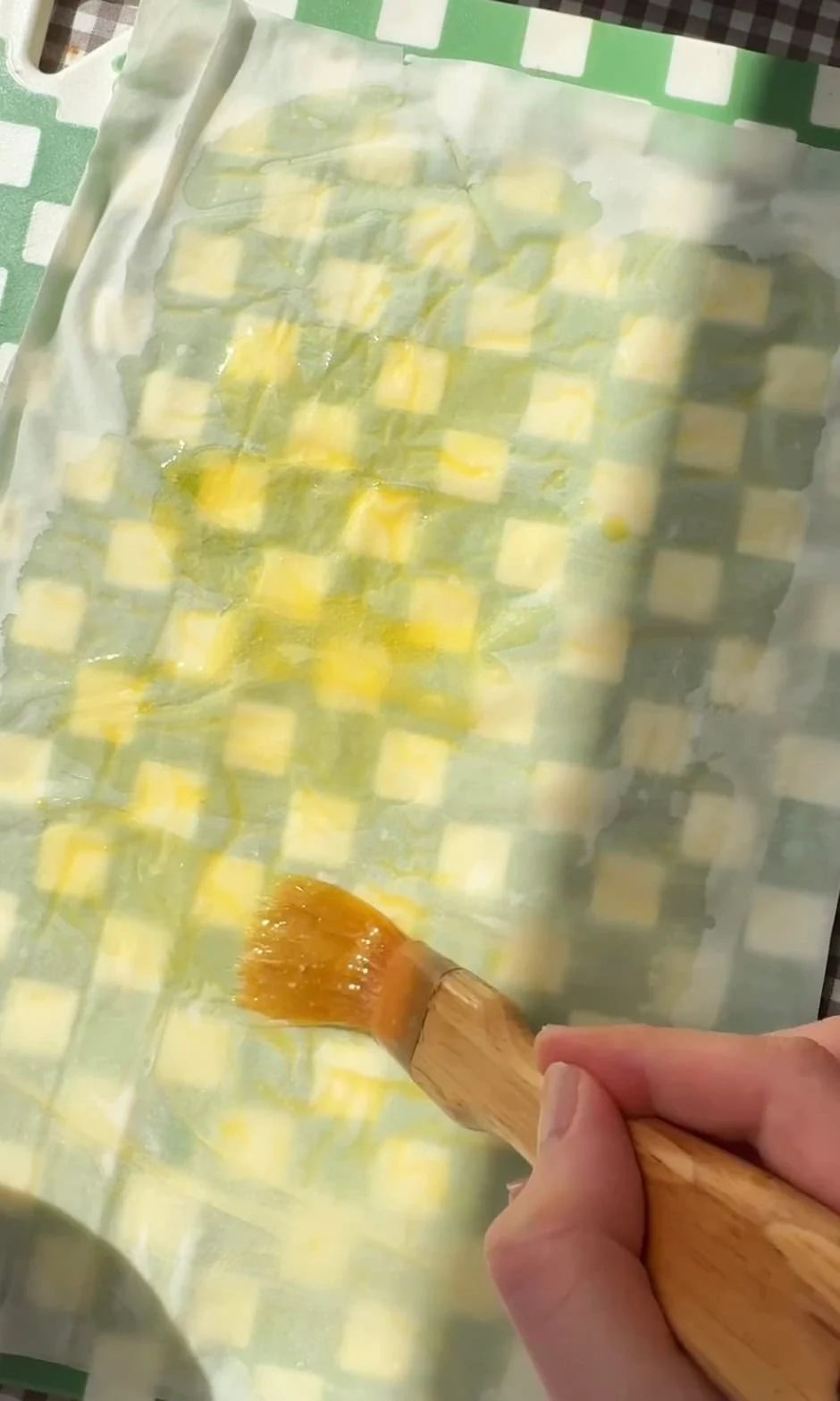 brushing filo pastry with butter.