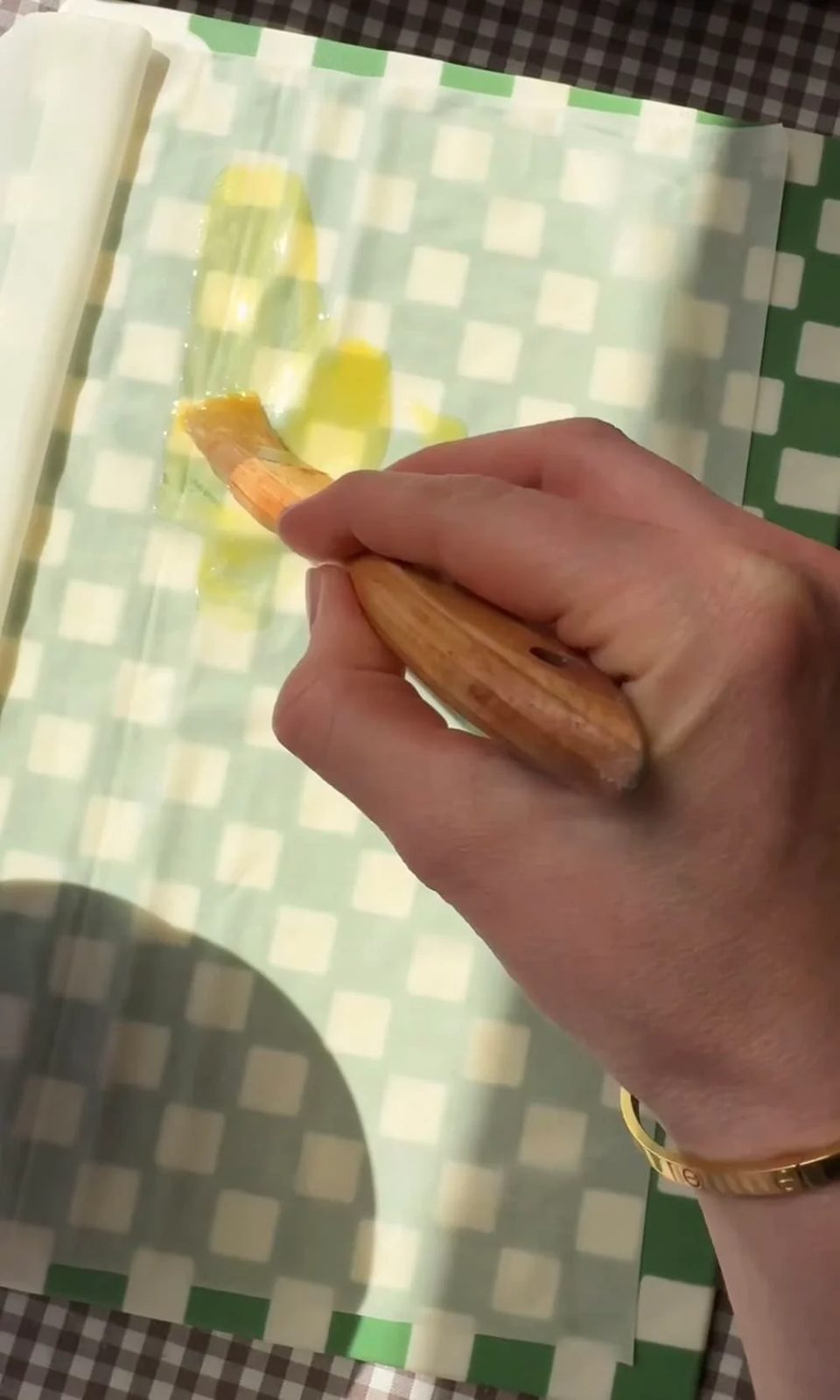 brushing filo pastry with butter.