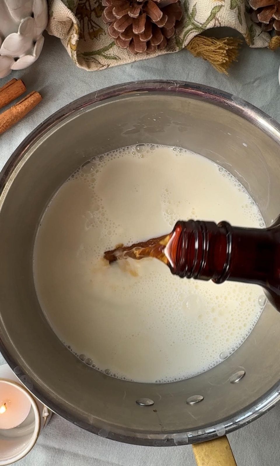 Pouring vanilla and cinnamon to the milk.