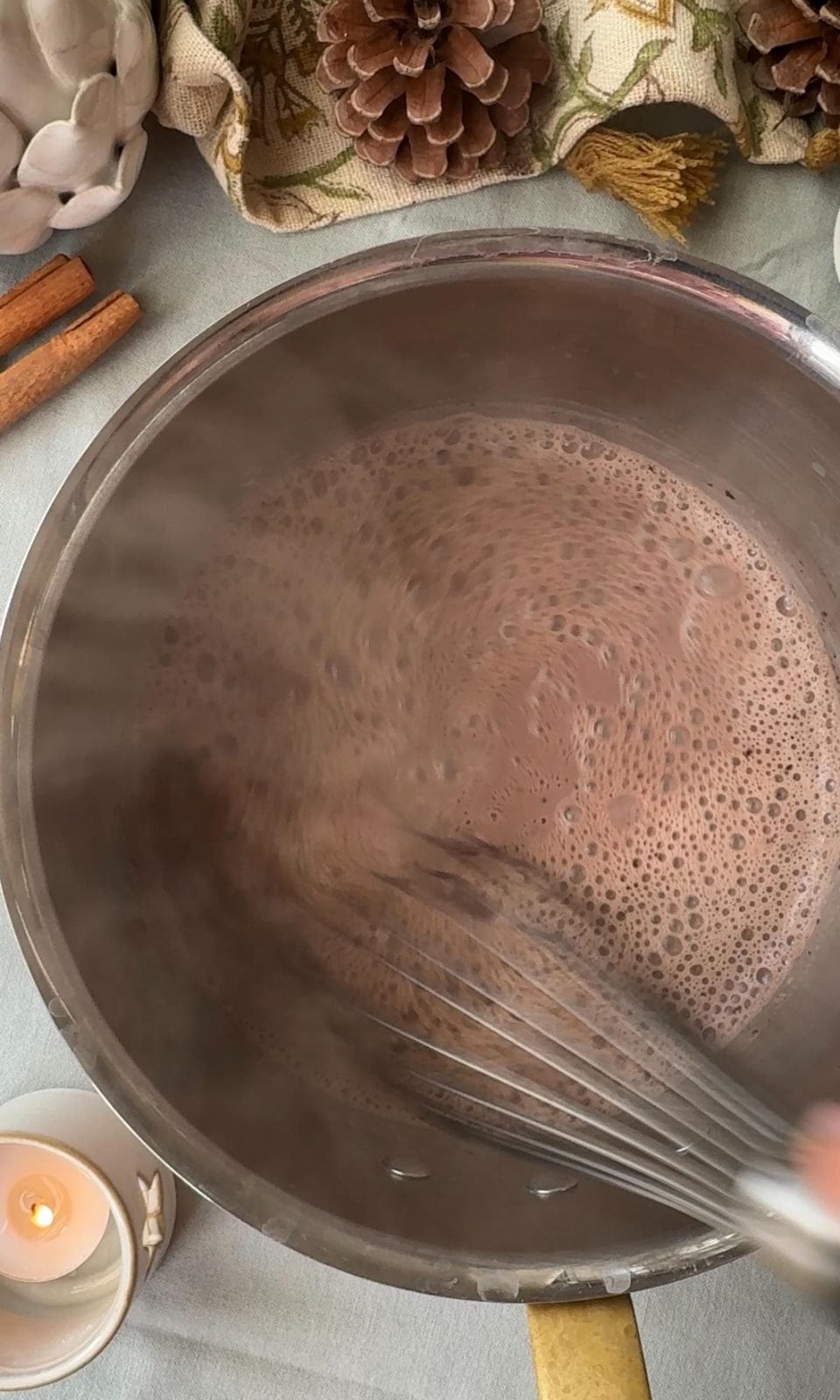 Whisking hot chocolate in a pan.