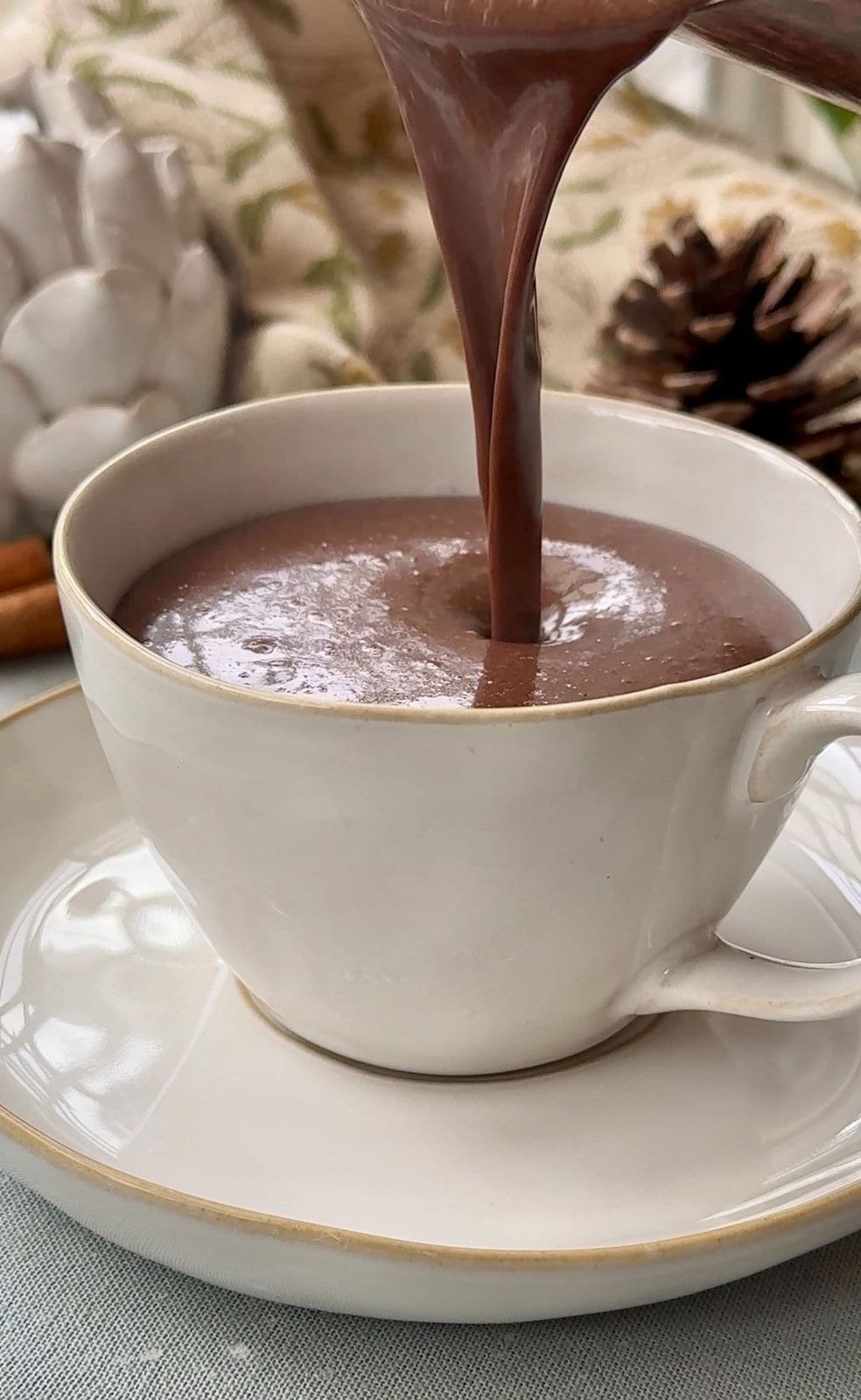 Pouring French hot chocolate into mug.