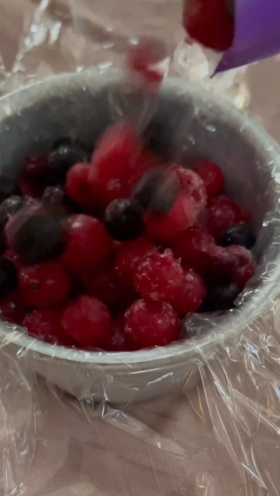 adding frozen berries to the ramekin