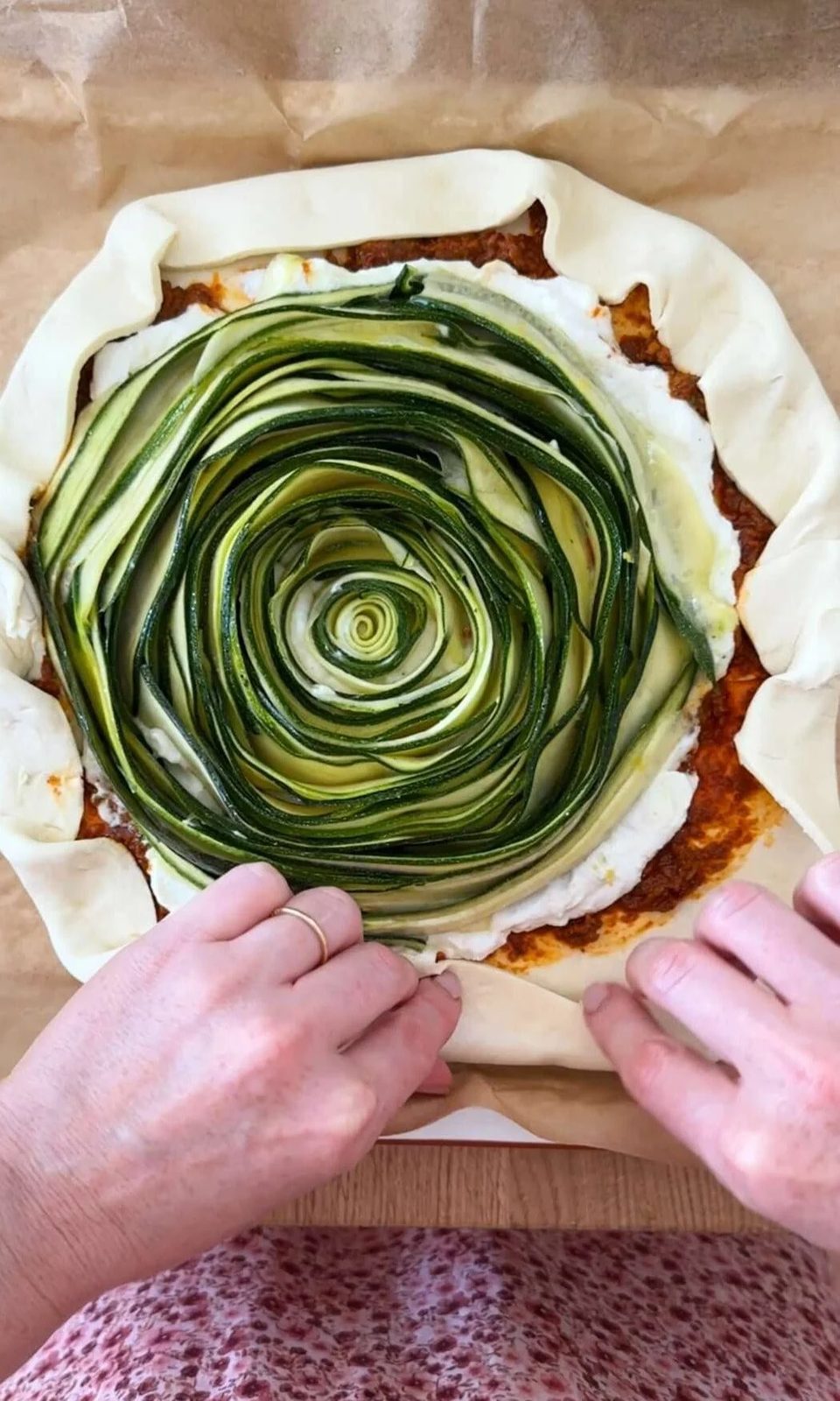 folding the edges of the galette de courgette.