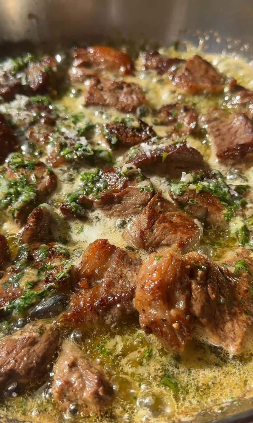 Adding the steak bites to the garlic butter.