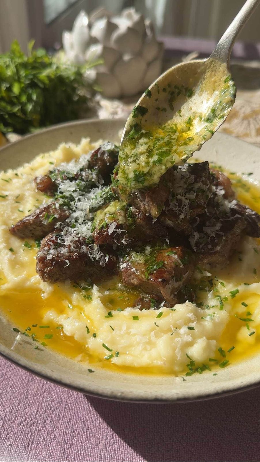 Pouring garlic butter over garlic steak bites.