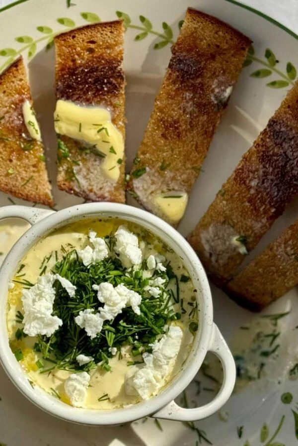 baked eggs and feta on a plate with toast.