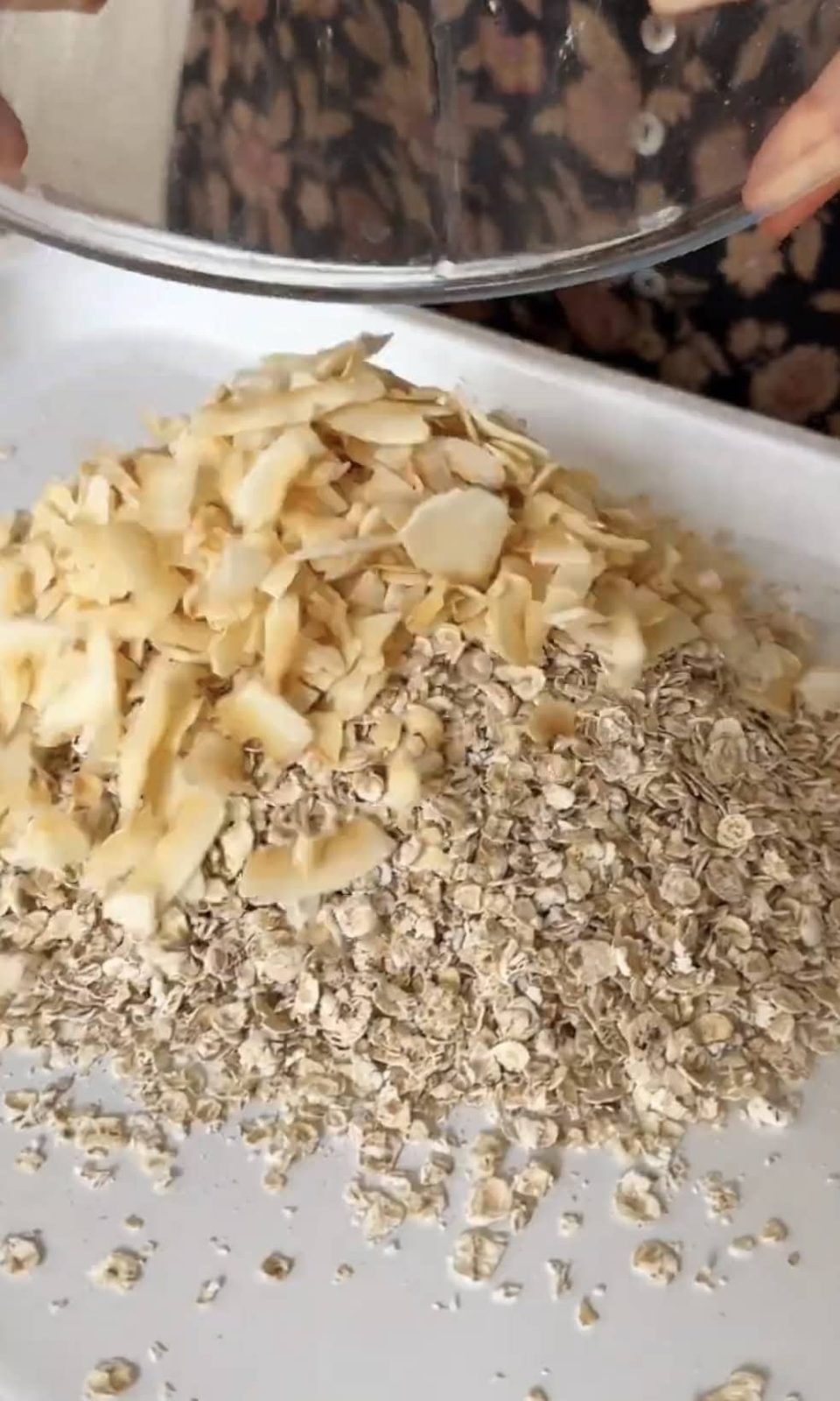 adding coconut to oats.