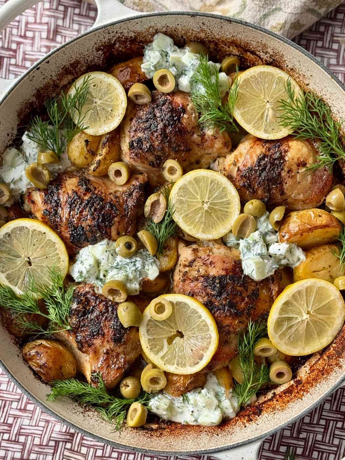 greek chicken lemon potatoes in a white dish.