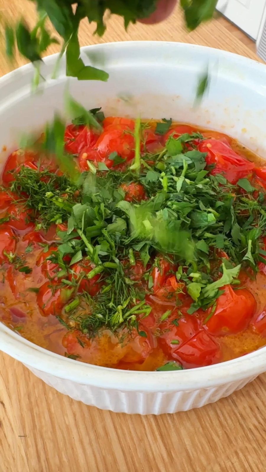 Adding chopped herbs to tomato salad dressing