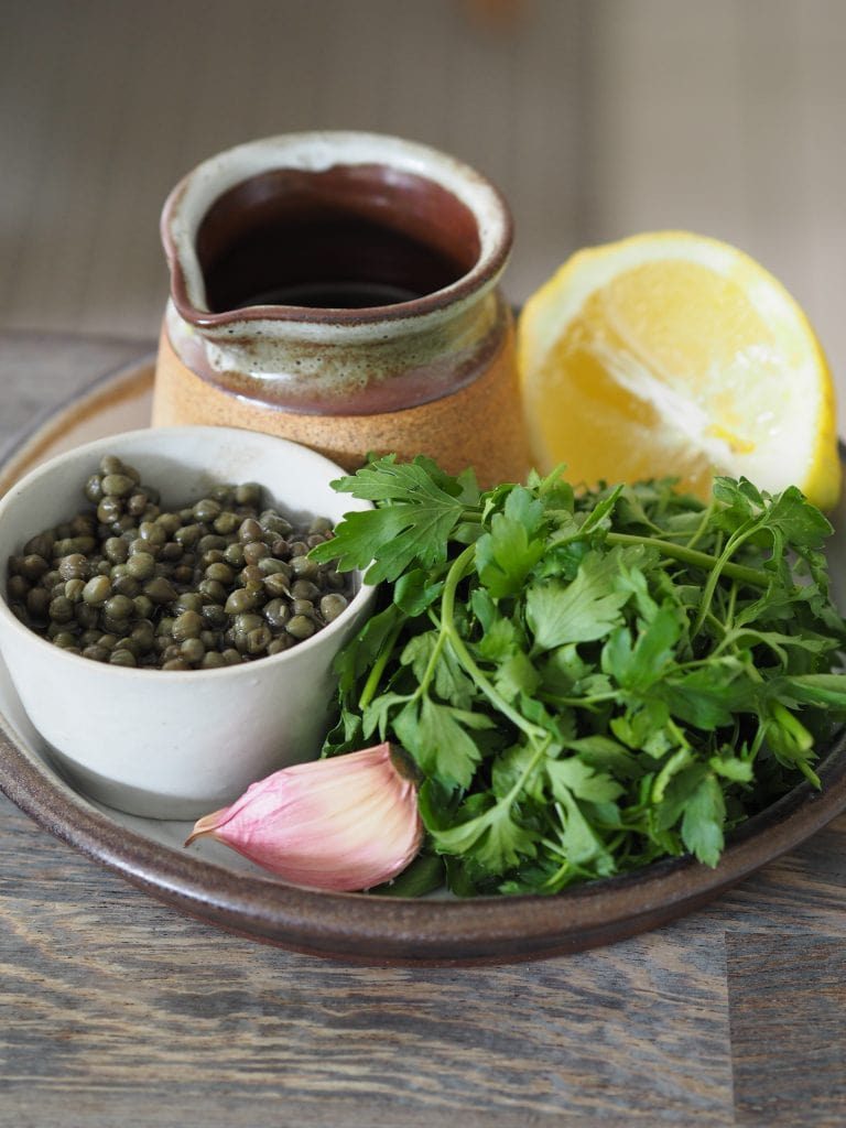 Salsa verde ingredients on a plate.