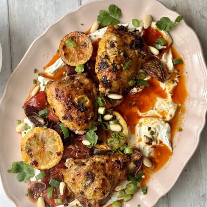 Harissa chicken on platter with labneh.