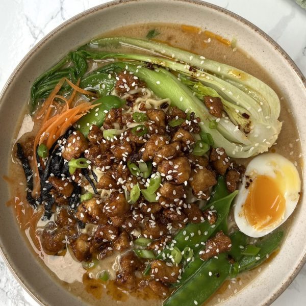Bowl of easy pork ramen topped with an egg and pak choy