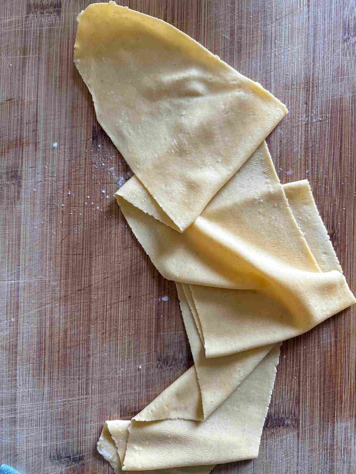 Pasta sheet on wooden board.
