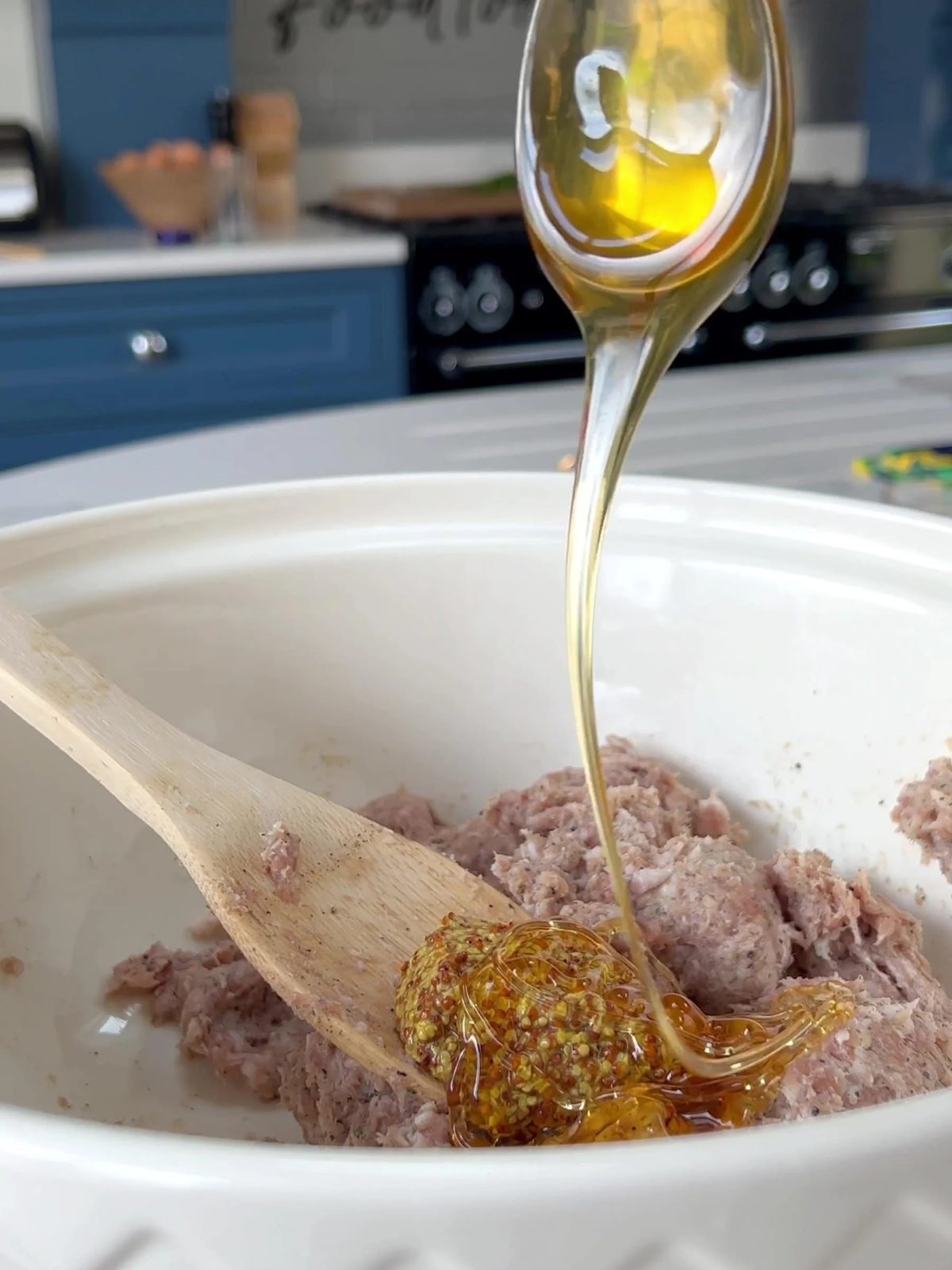 Adding honey to sausage meat.