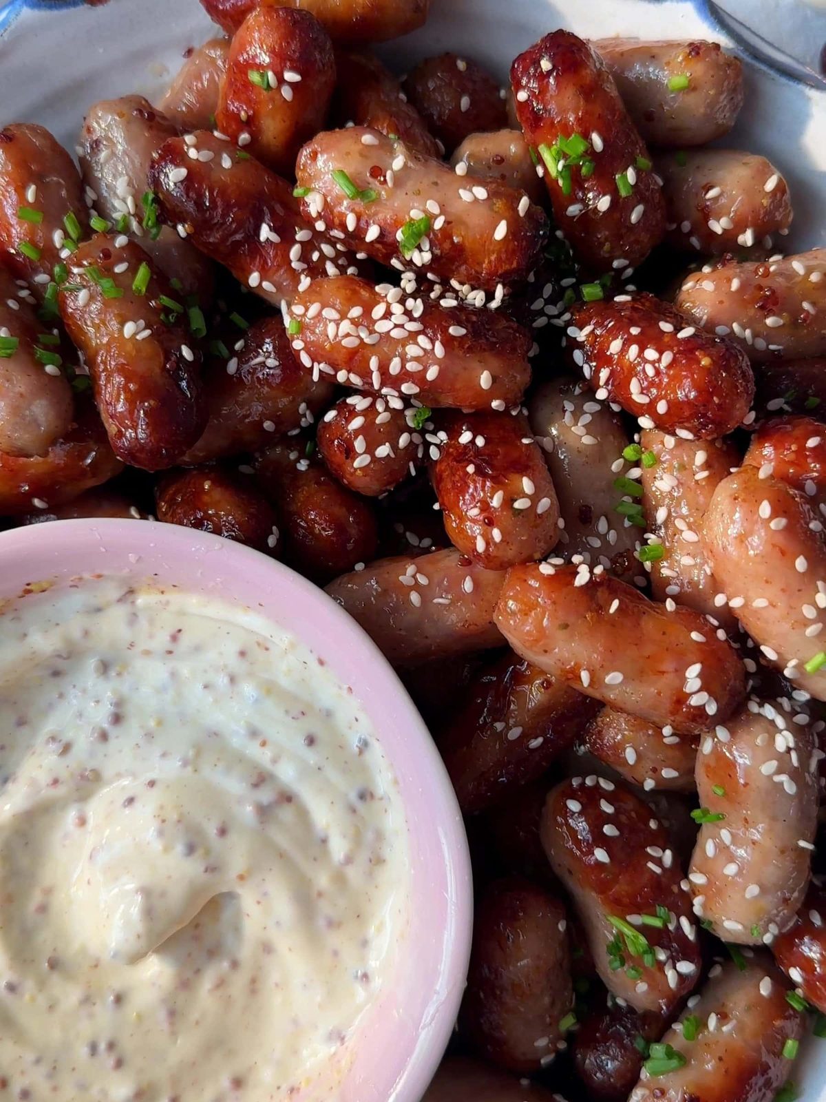 Honey Mustard Sausages with a bowl of mayo and mustard dip.