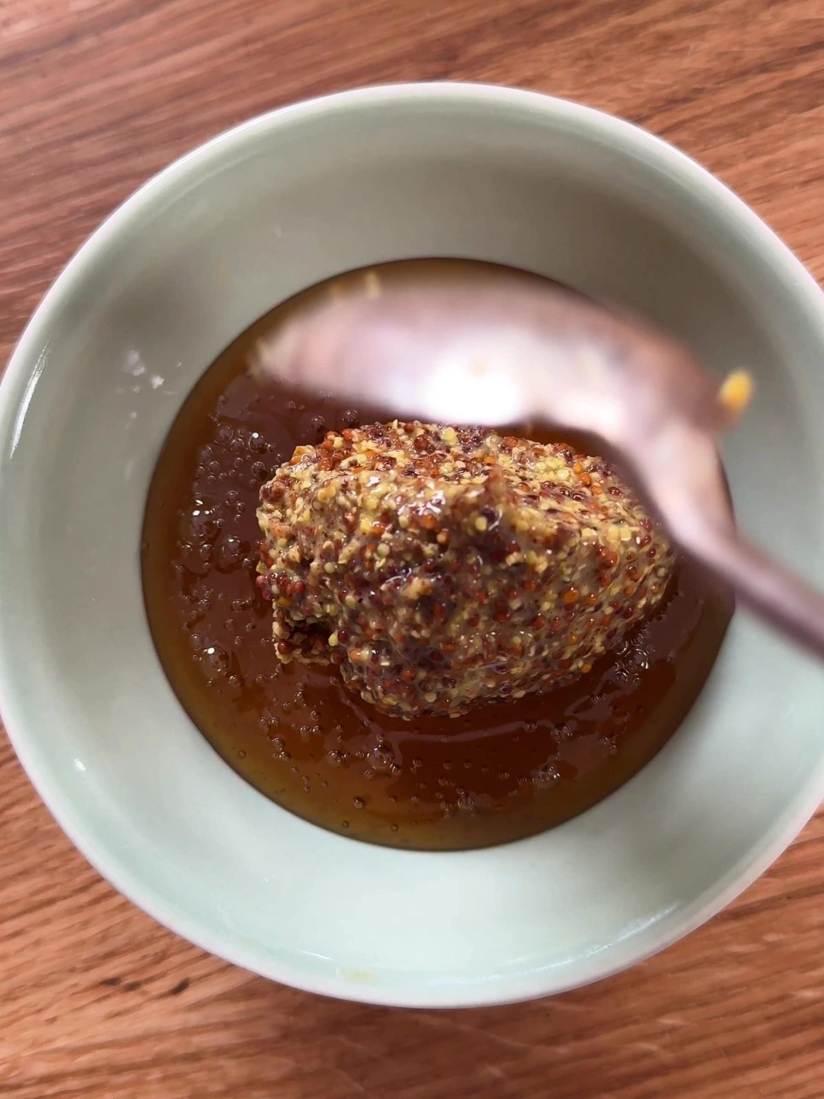 Mixing honey and mustard in a bowl.