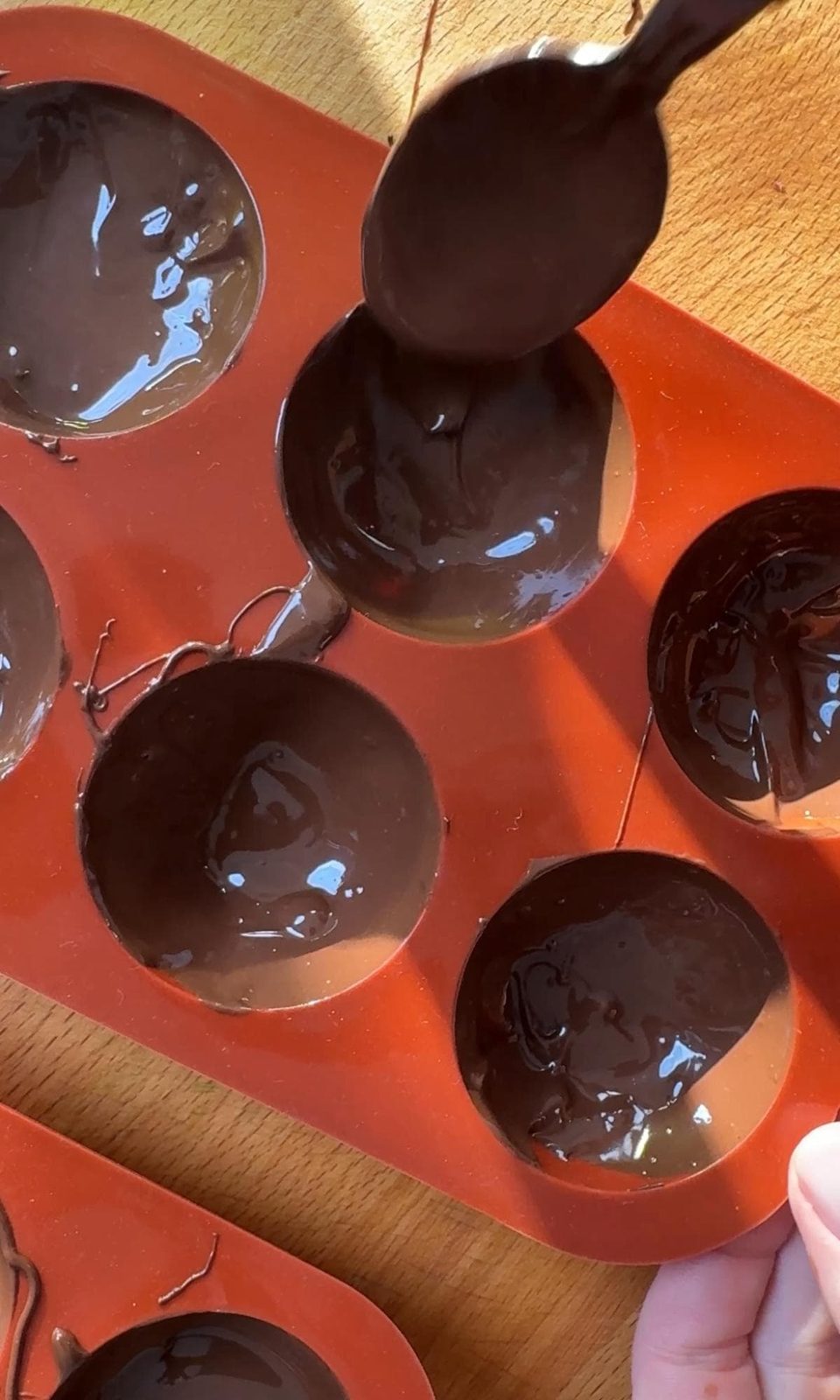 Smoothing chocolate shell for bombs.
