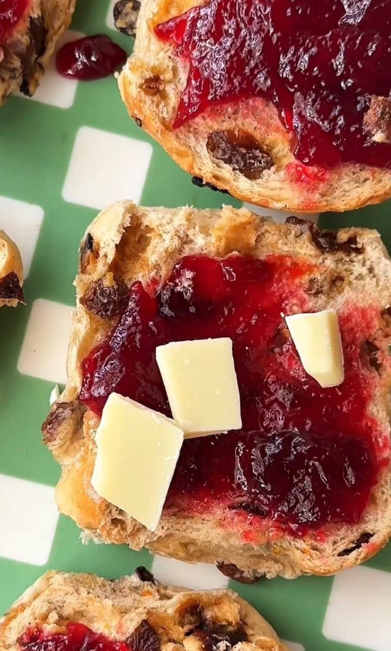 adding white chocolate on hot cross bun.