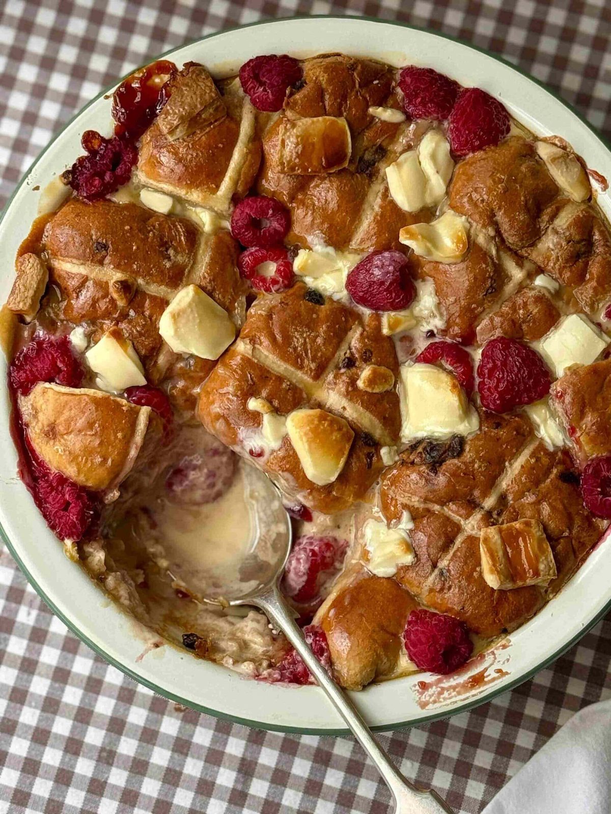 hot cross bun bread and butter pudding with a spoon.