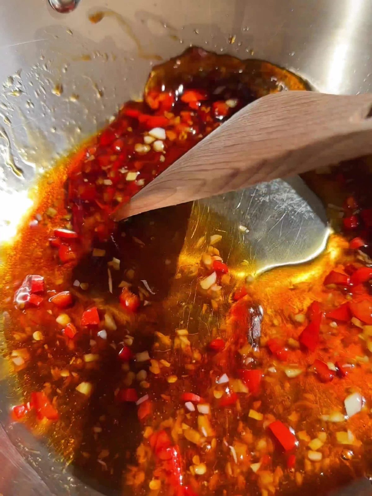 Making honey chili sauce in pan.