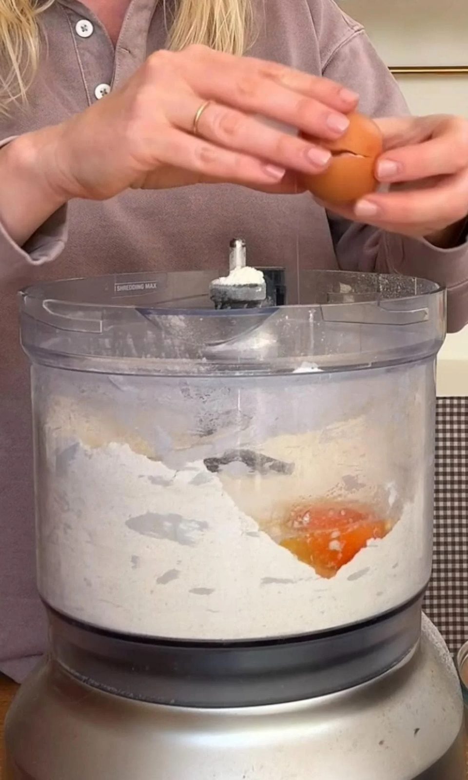adding eggs to shortcrust pastry.