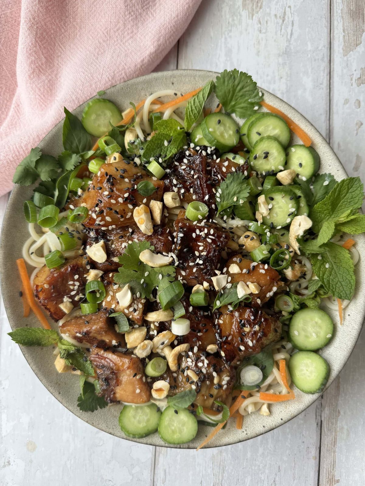 Sticky pork belly with veggies on plate.