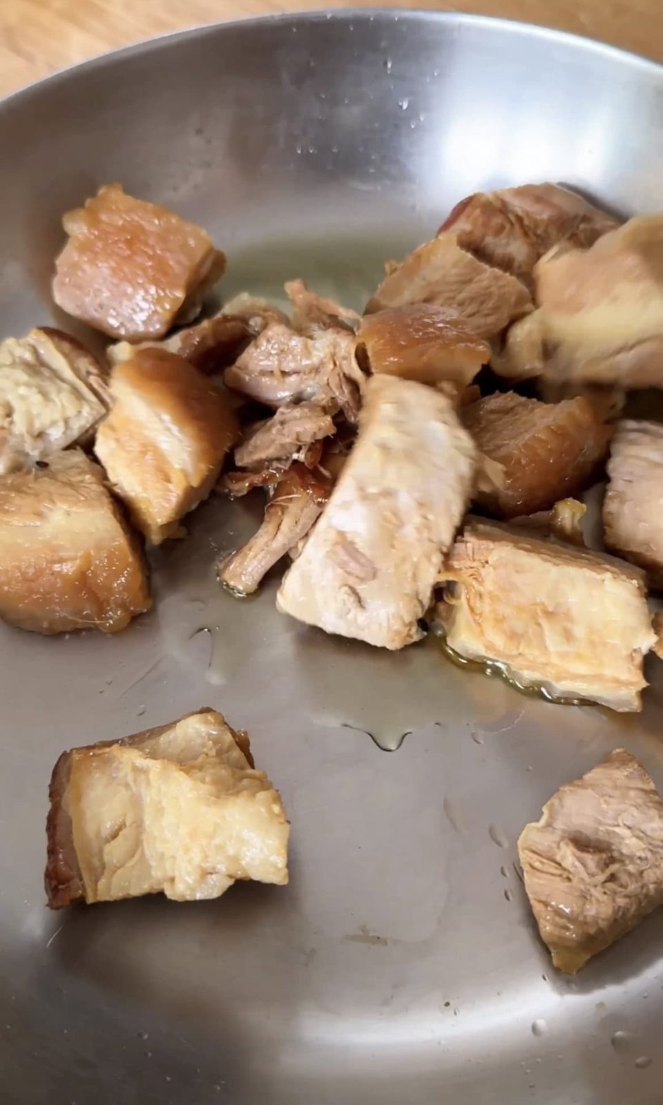 Frying pork belly chunks.