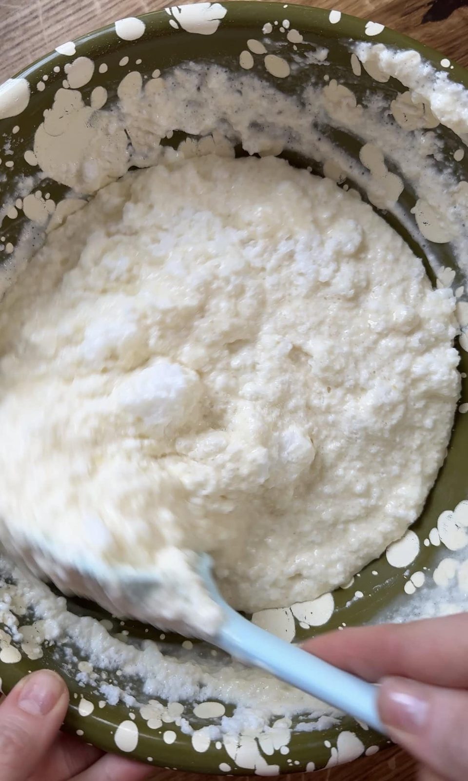 Folding egg whites into pancake batter.
