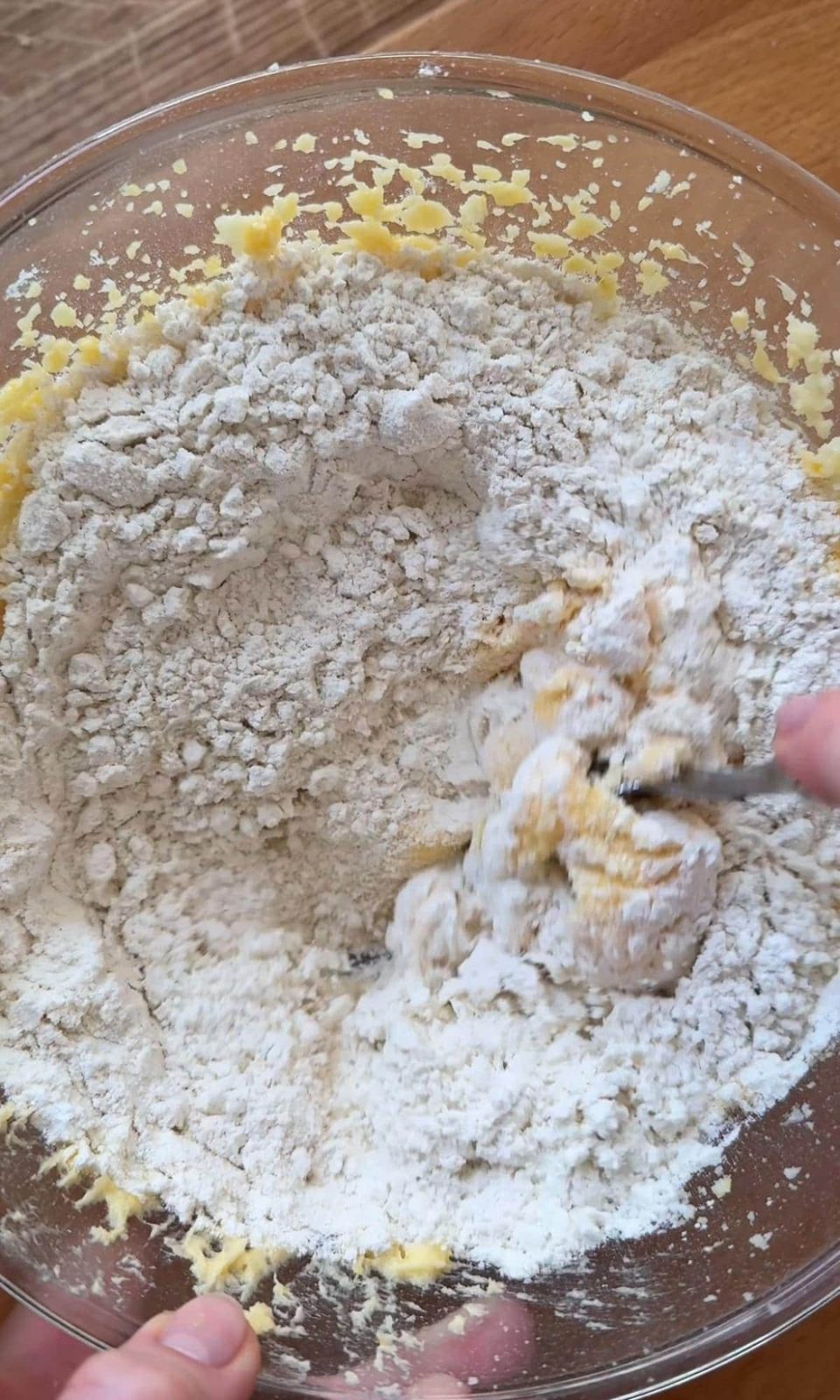 Adding flour to muffin mix.
