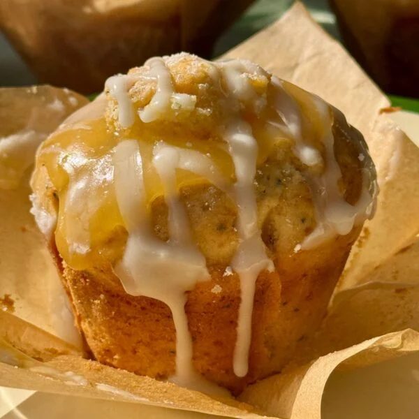 one lemon and poppy seed muffin on baking paper.
