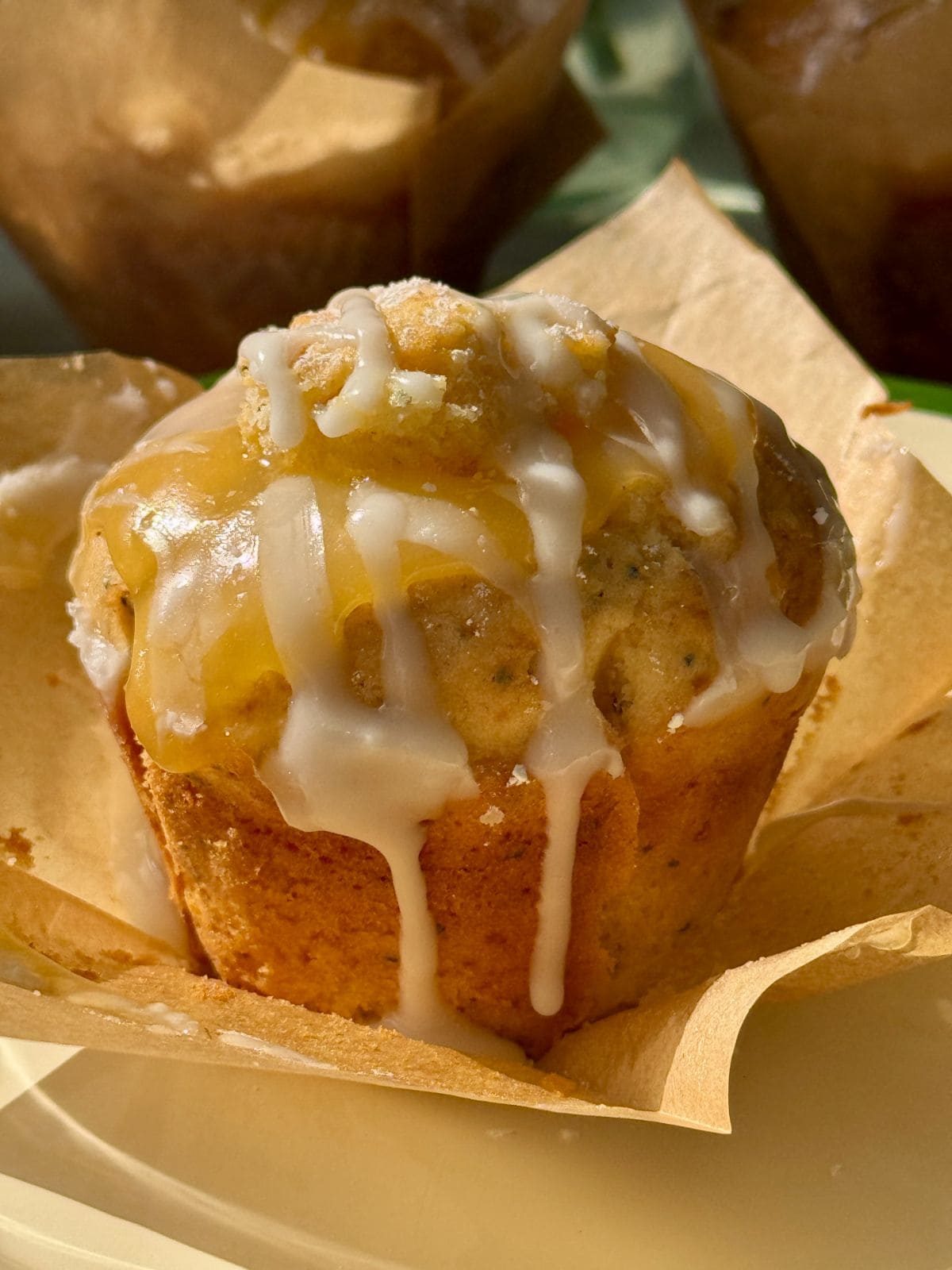 One lemon and poppy seed muffin on baking paper.