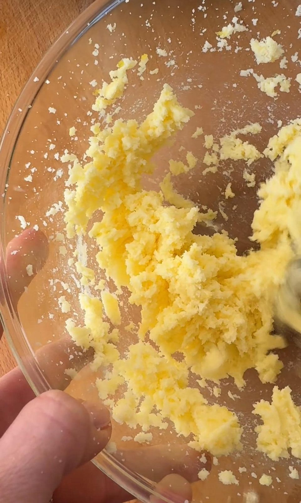 Creaming butter and lemon sugar together.