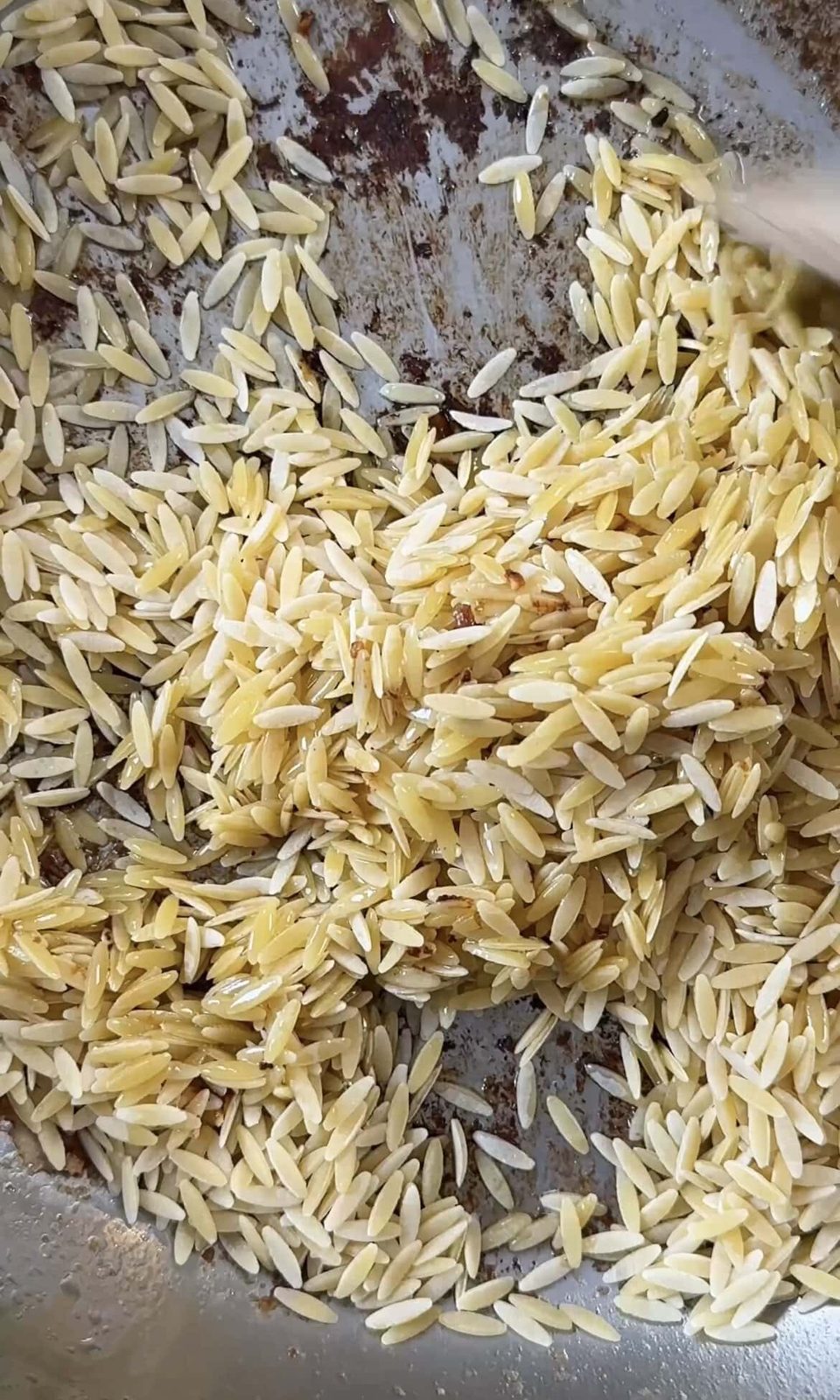 Toasting orzo in pan.