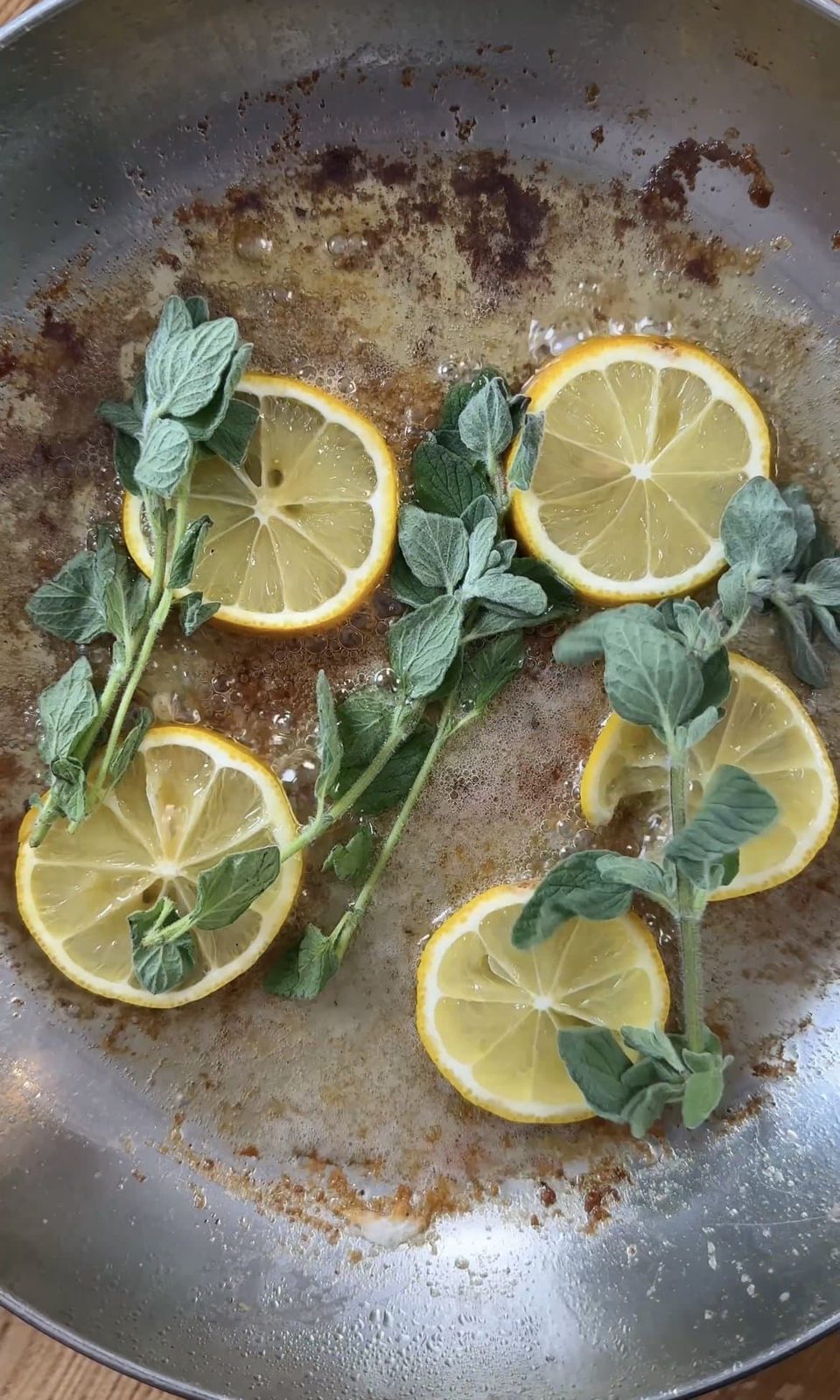 Frying lemon and oregano in butter.