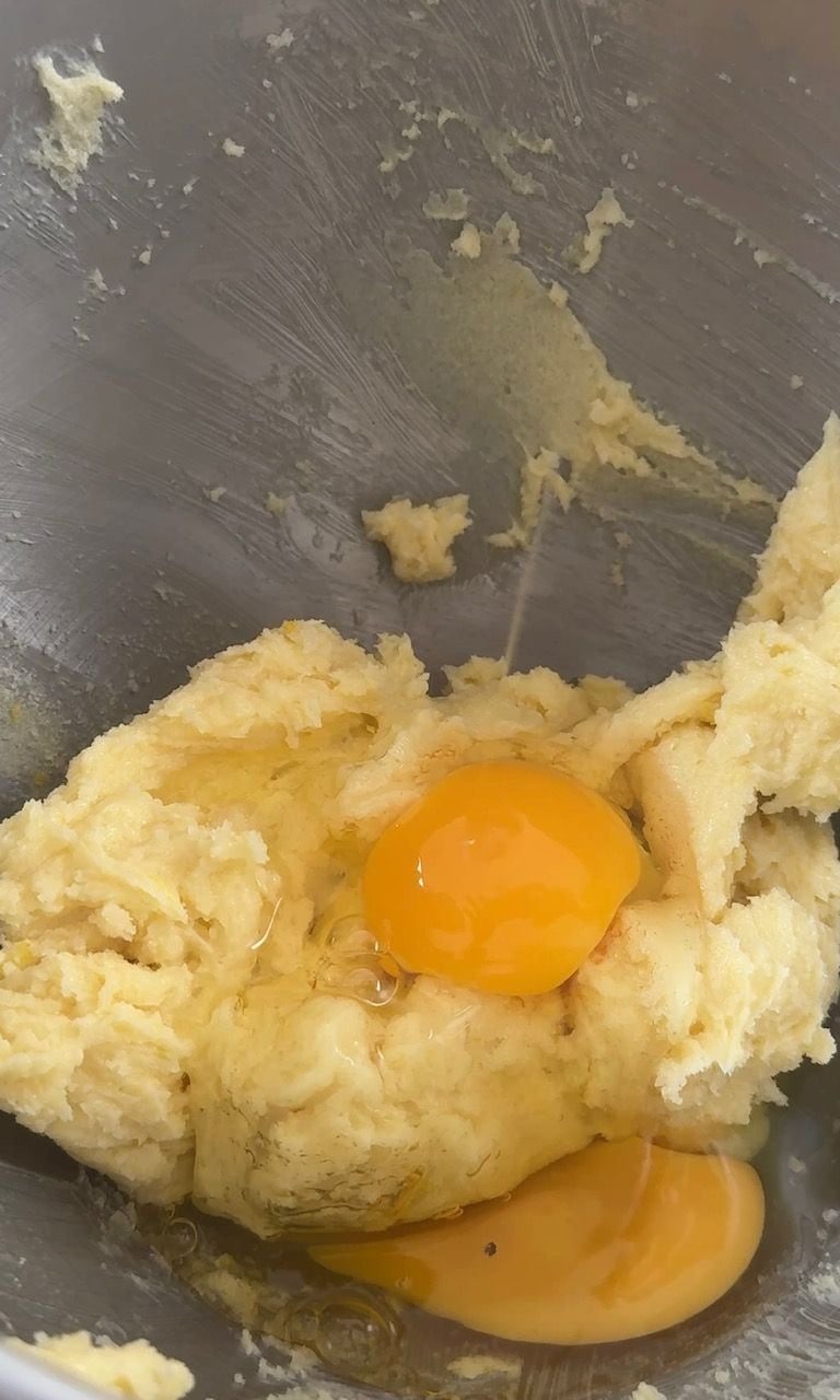 adding eggs to butter and sugar.