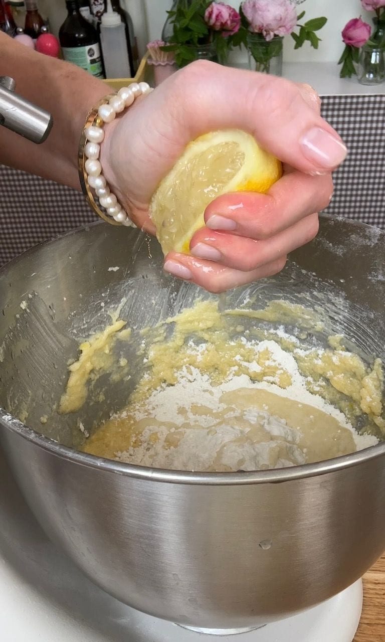 squeezing lemon juice into the cake.