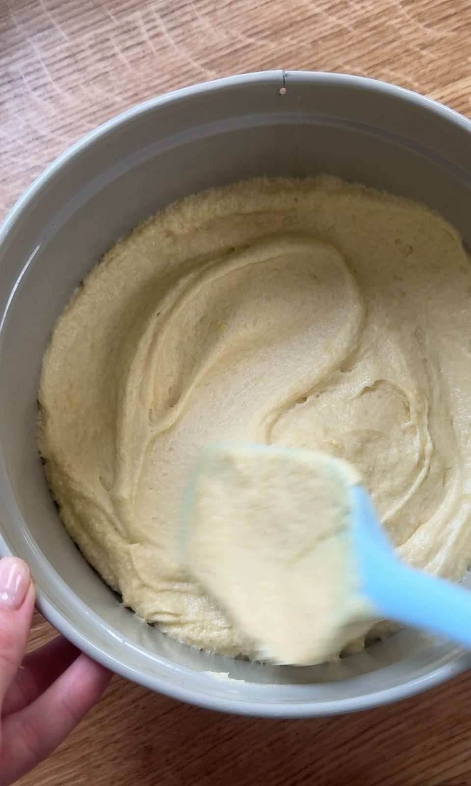smoothing cake batter into the tin.