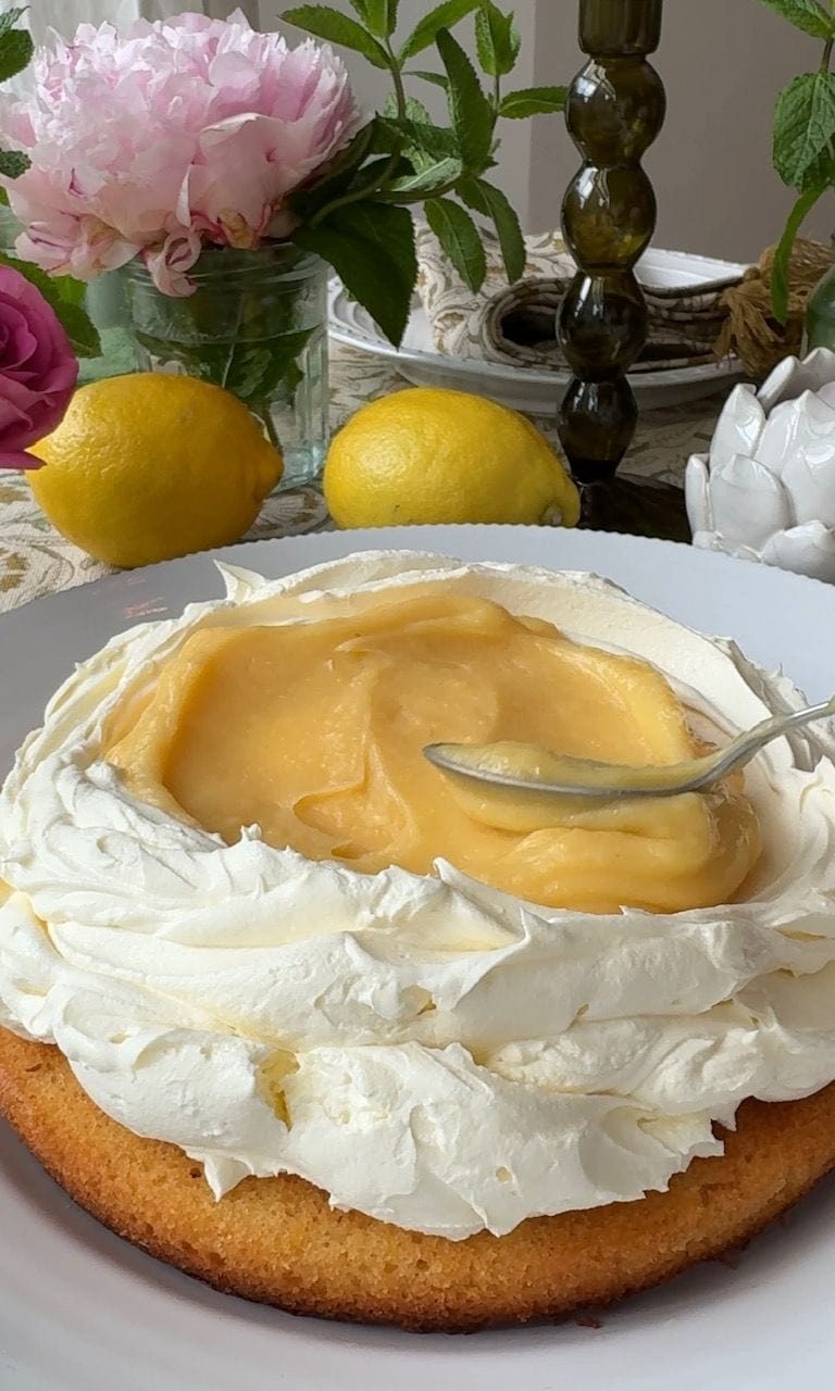 adding lemon curd to cake.