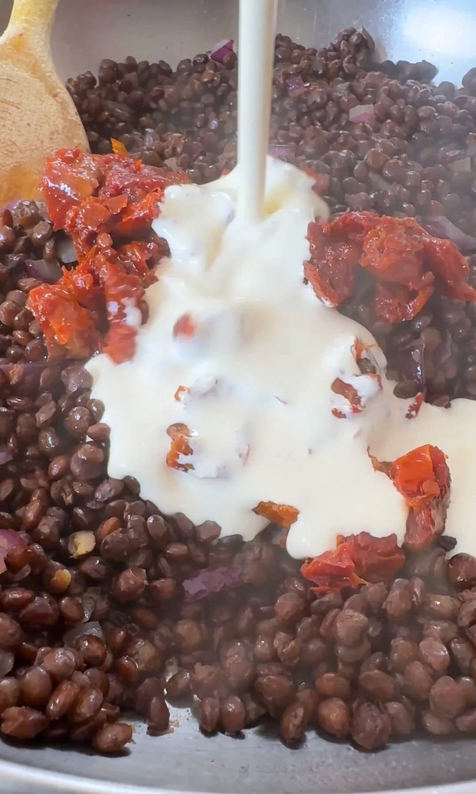 adding lentils and cream to pan.