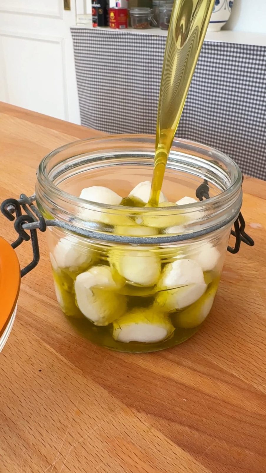 pouring olive oil on mozzarella balls