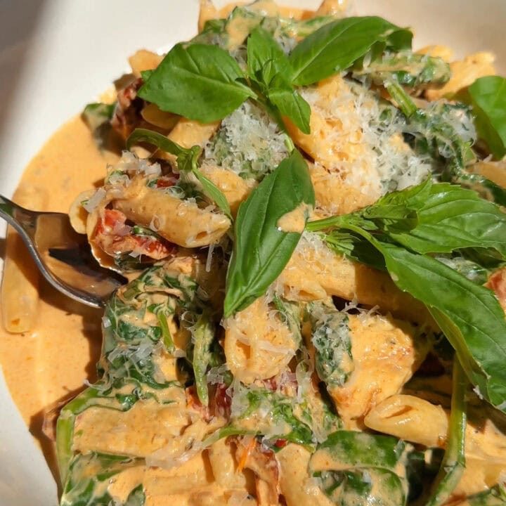 marry me chicken pasta in a white bowl close up.