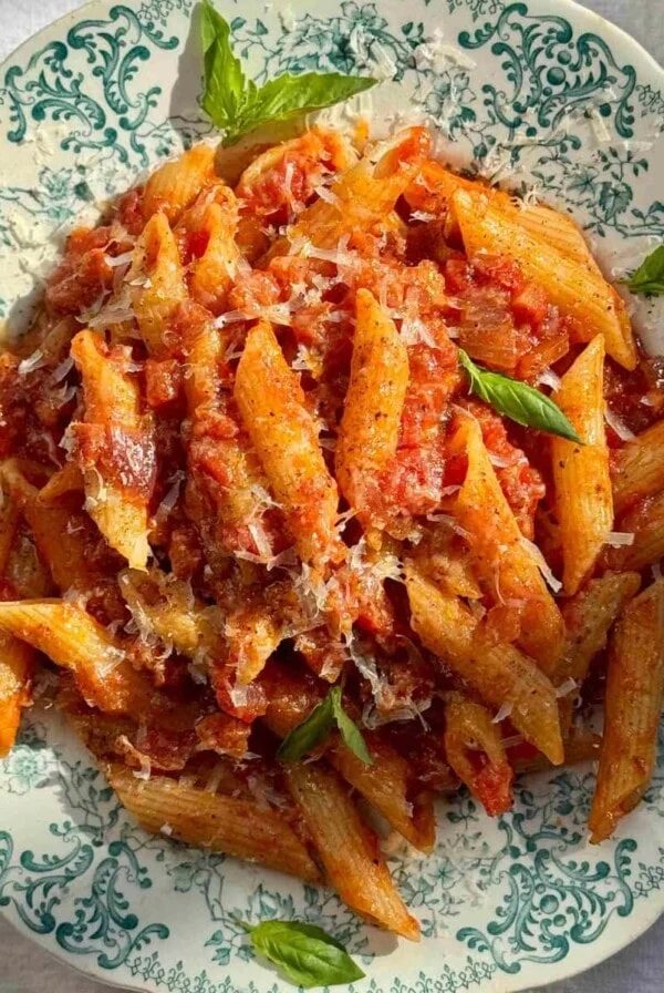 penne amatriciana in a blue bowl.