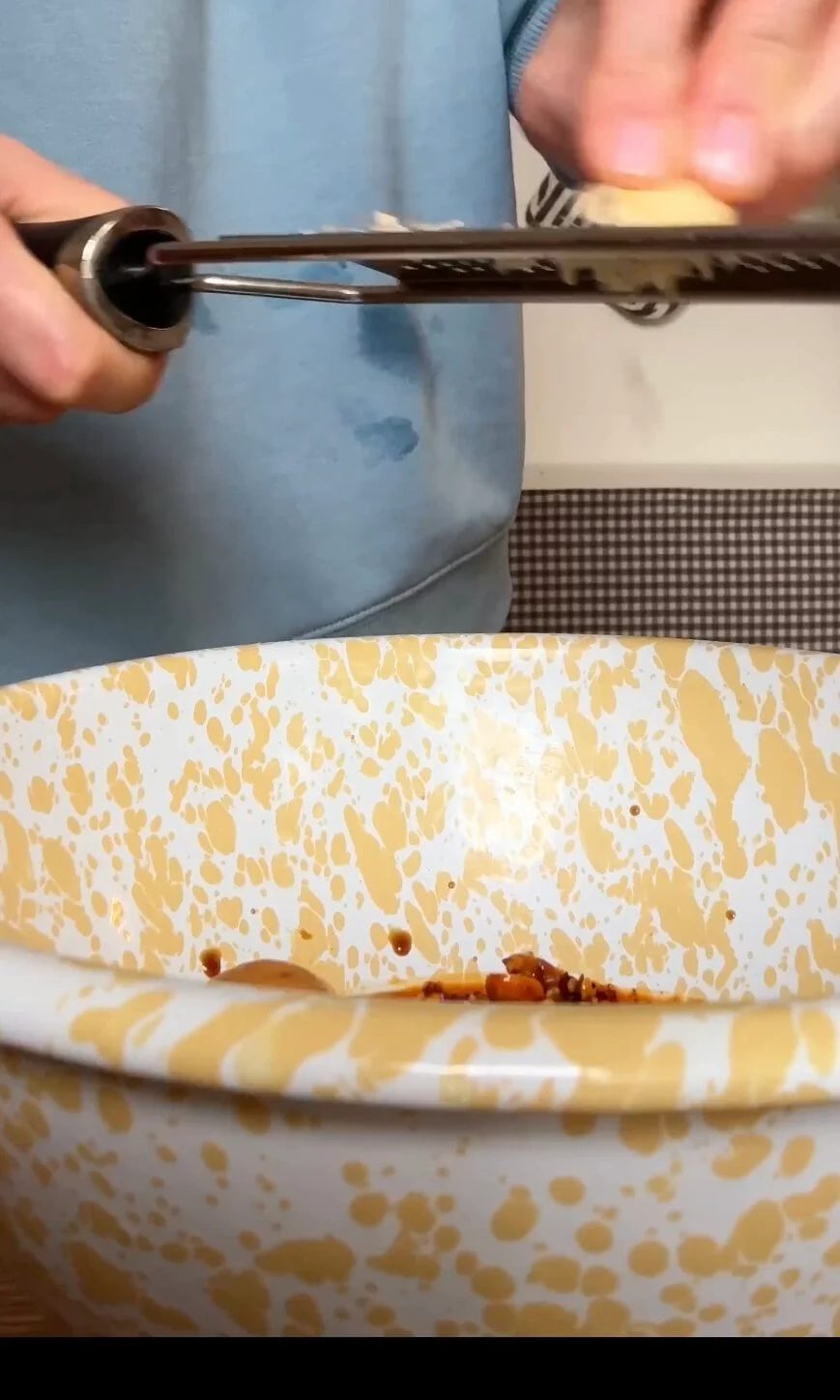grating garlic into the peanut sauce.