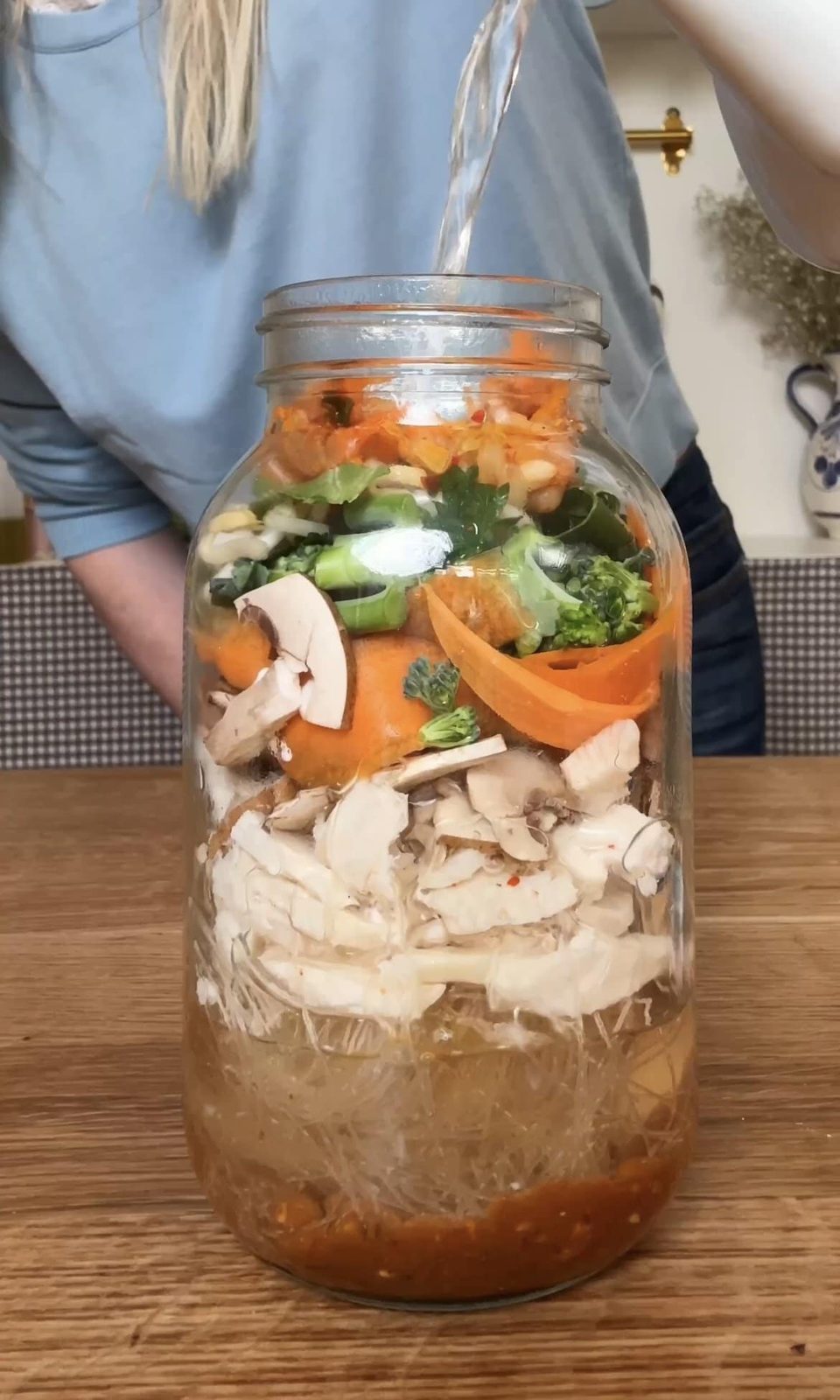 pouring boiling water into the mason jar.